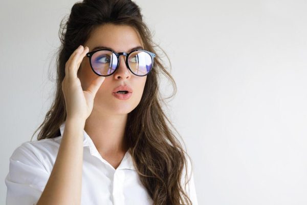 young-woman-wearing-eyeglasses-on-gray-background-photo